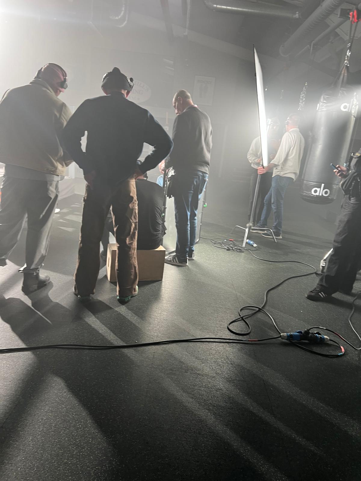 Crew and lighting team working on a smoky film set